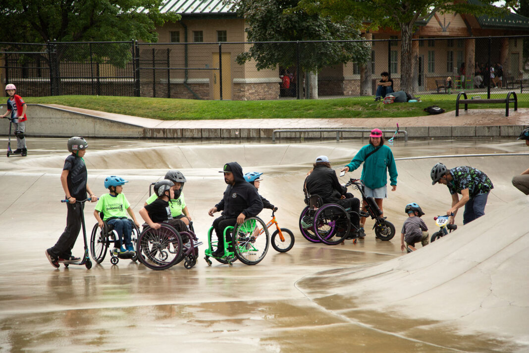 Young adaptive athletes visiting on a skate park with pro athlete