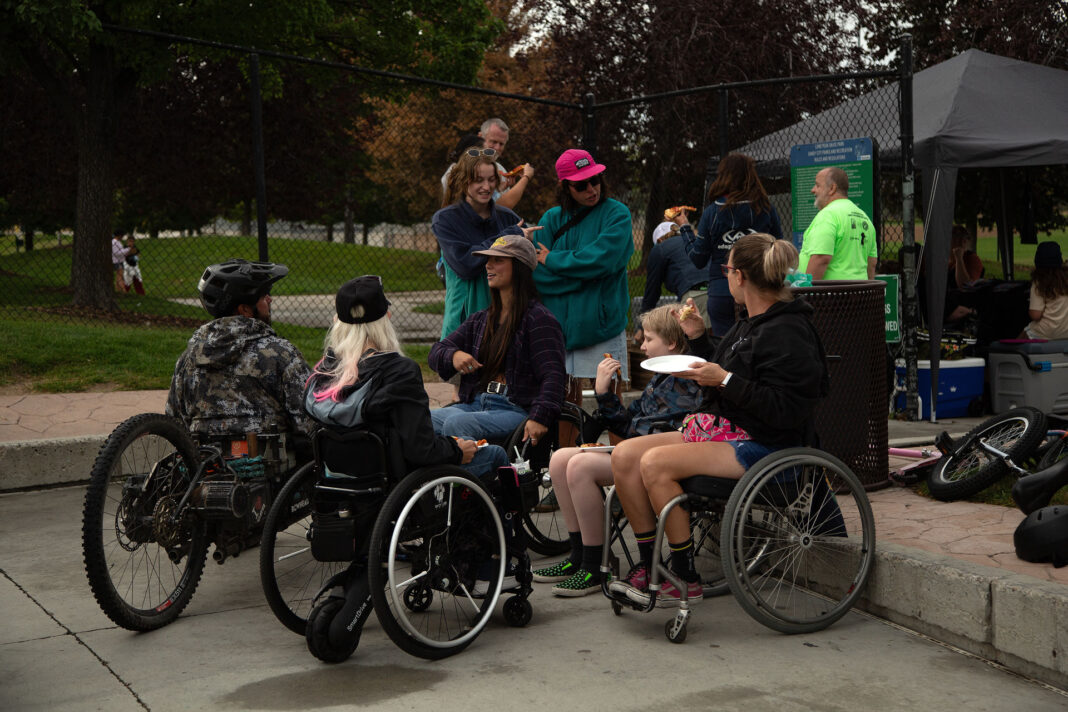 People conversing outside at a skate park