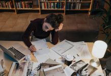 Tips and resources for managing semester stress Woman reading a script while sitting at a cluttered desk