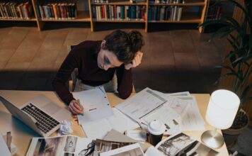 Tips and resources for managing semester stress Woman reading a script while sitting at a cluttered desk
