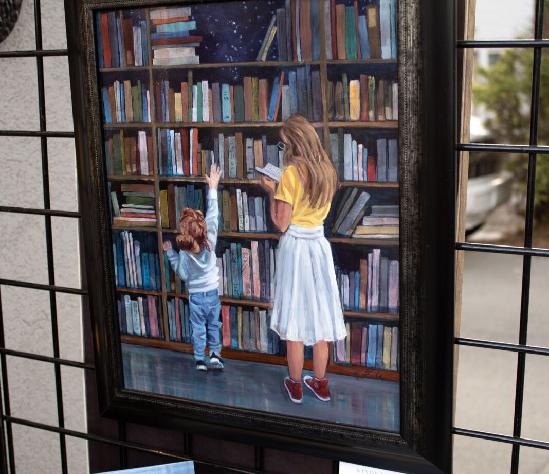 Painting depicting a woman and child browsing books