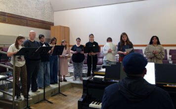 SLCC Choir tunes up for a busy season Juan playing piano as choir students sing a song