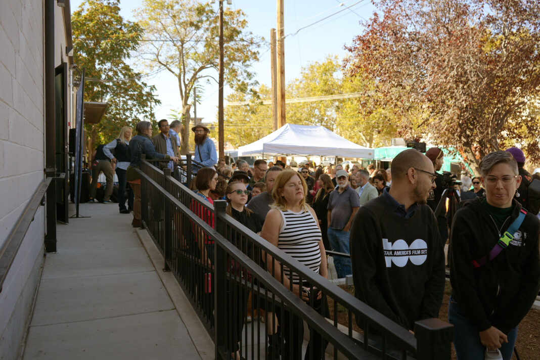 People standing in line outside a building entrance