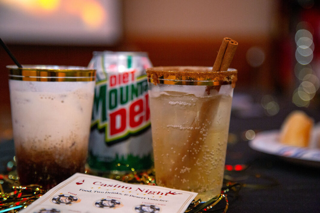 Drinks and a punch card sitting on a casino table