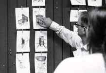 Architecture professor praises community, affordability, and student growth within program Black-and-white photo of an instructor discussing sketches with a student