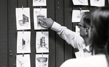 Architecture professor praises community, affordability, and student growth within program Black-and-white photo of an instructor discussing sketches with a student