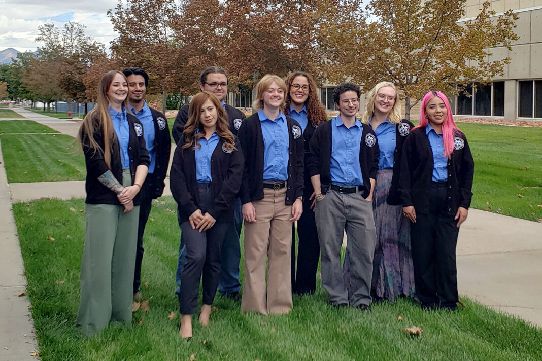 Group photo of students wearing blue shirts and blazers