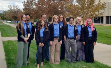 Lactobruins heading to Paris for iGEM science competition Group photo of students wearing blue shirts and blazers