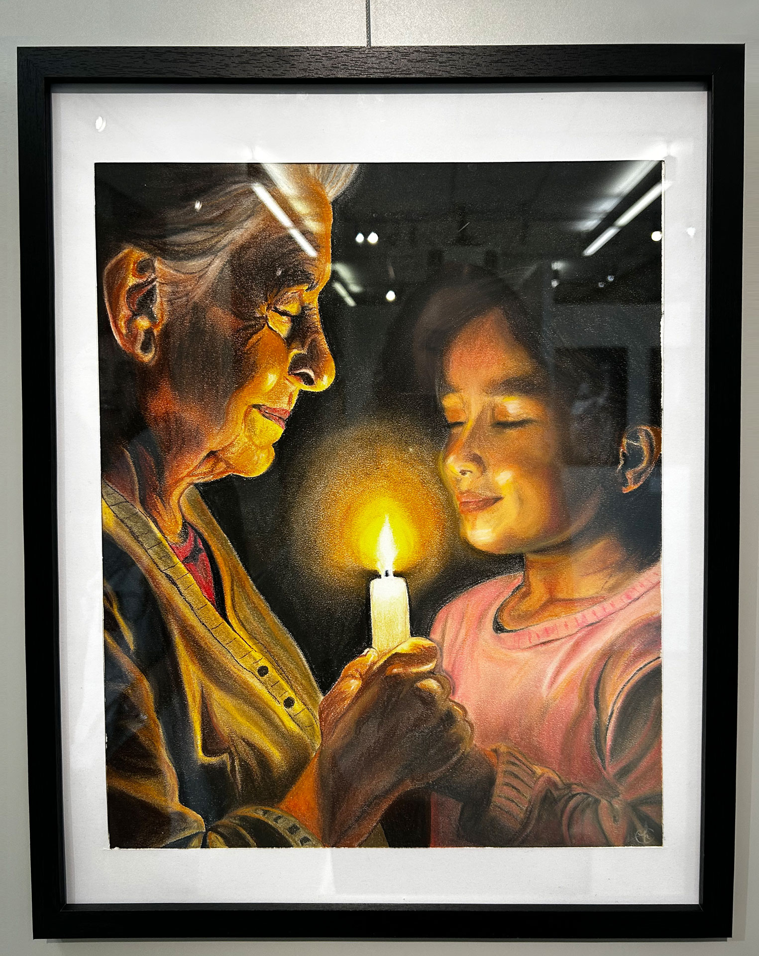 Framed painting of an old woman and a girl holding a candle