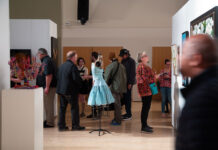 31st President’s Art Show celebrates creativity and community Several people looking at art exhibits in a multipurpose room