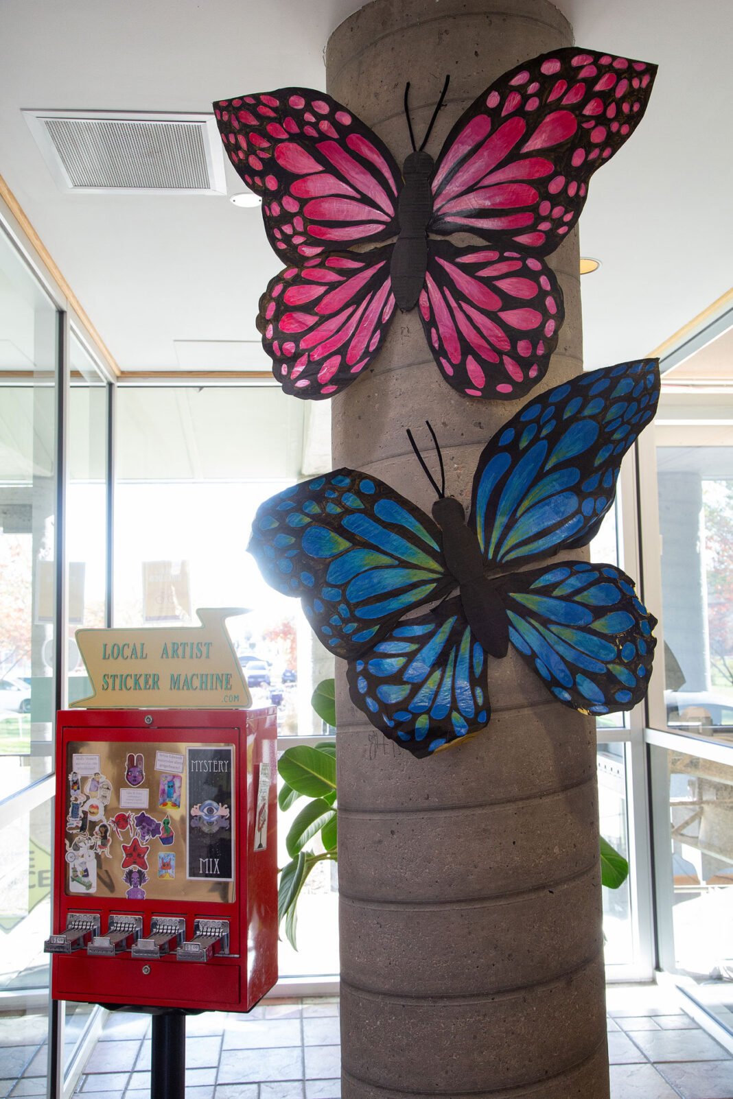 Pink and blue butterflies in a concrete pillar
