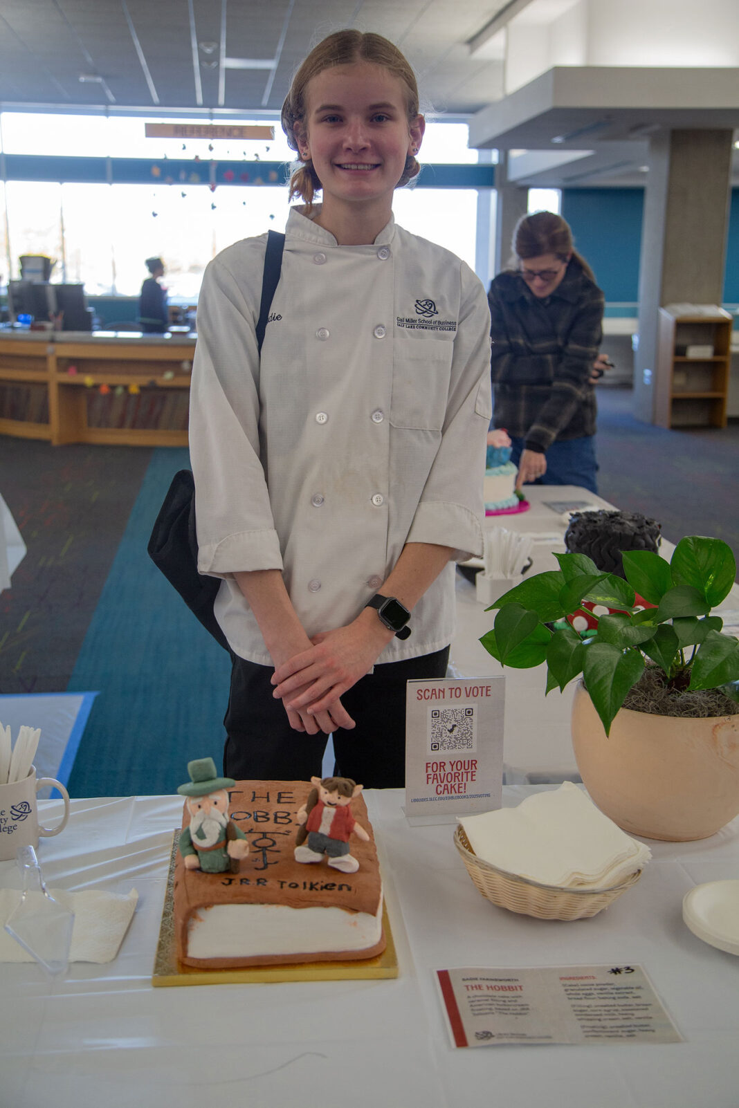 Sadie standing behind her winning cake design