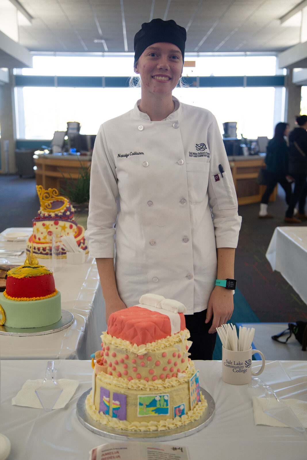Natalya standing behind her winning cake design