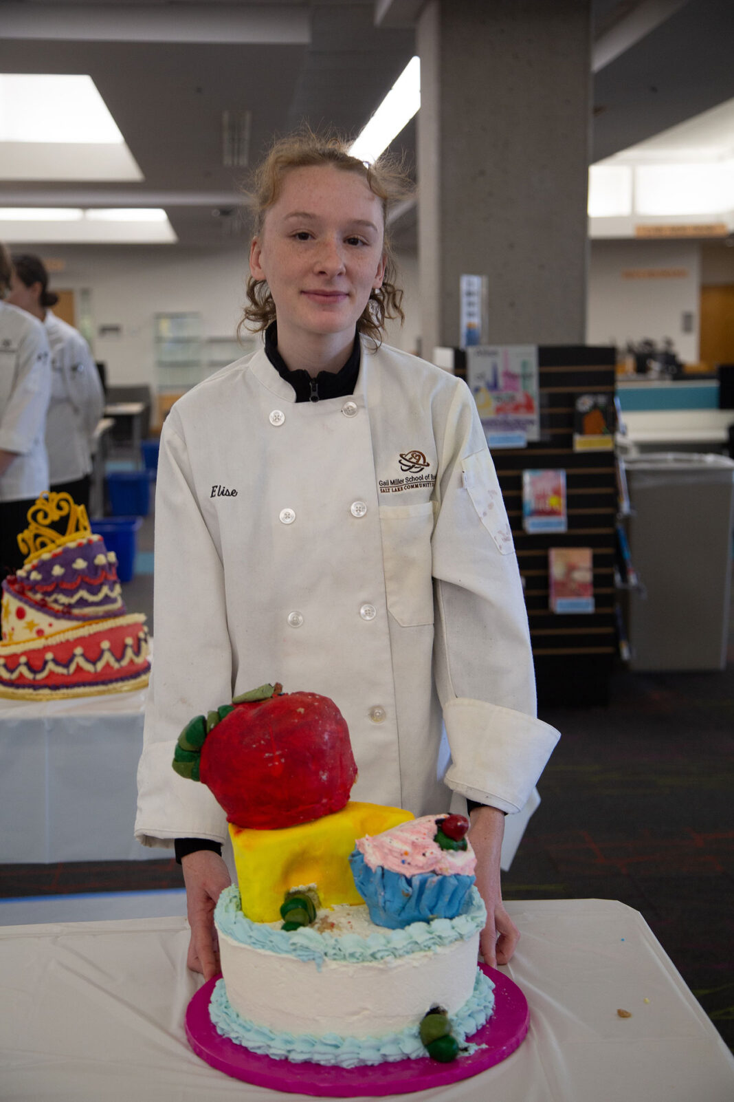Elise Robison standing with her winning cake design