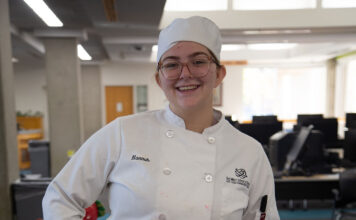 Photos: Edible Books Contest mixes creativity, literacy Hannah standing behind her winning cake design