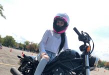 Motorcycle course builds confidence, safety knowledge for new riders Katelyn wearing a helmet while seated on her motorcycle