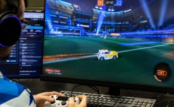 SLCC esports team loses scholarship access esports player using a controller in front of monitor displaying "Rocket League" gameplay