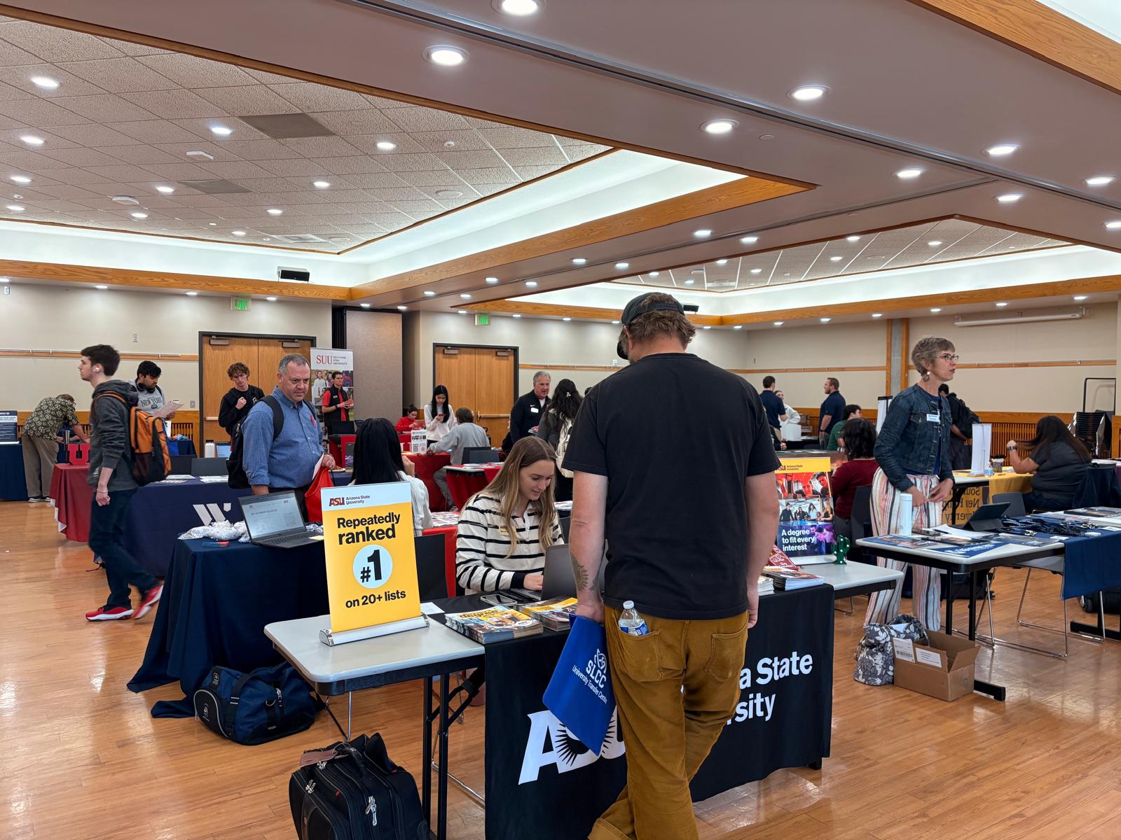 People visiting tables for college transfer information