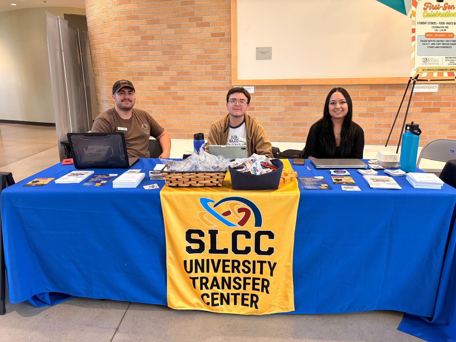 Three transfer staffers seated at a table waiting to assist students