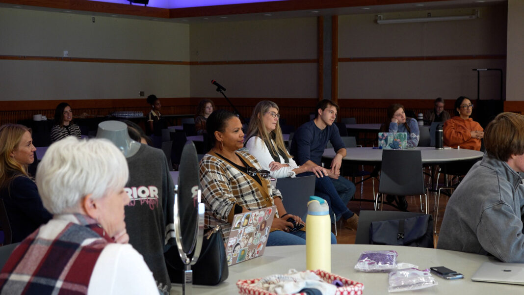 Audience members sitting at round tables in a forum