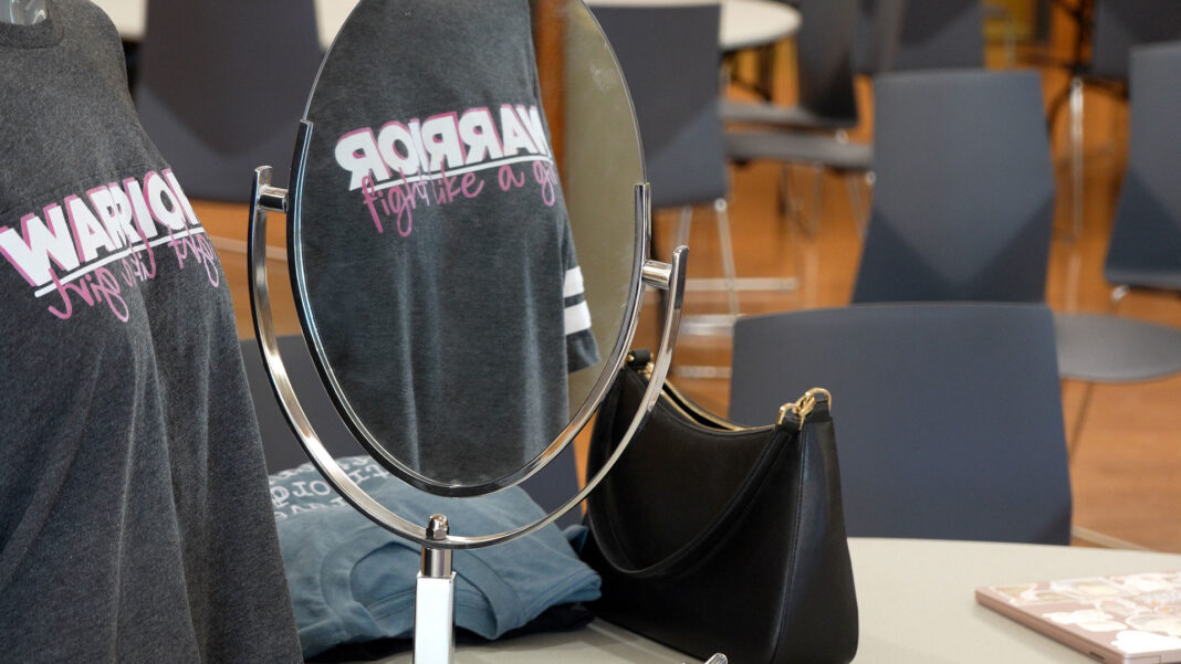 Mirror showing the reflection of a shirt design