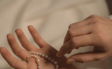 Poem: ‘The Serendipity Prayer’ a person's hands holding a pearl bracelet