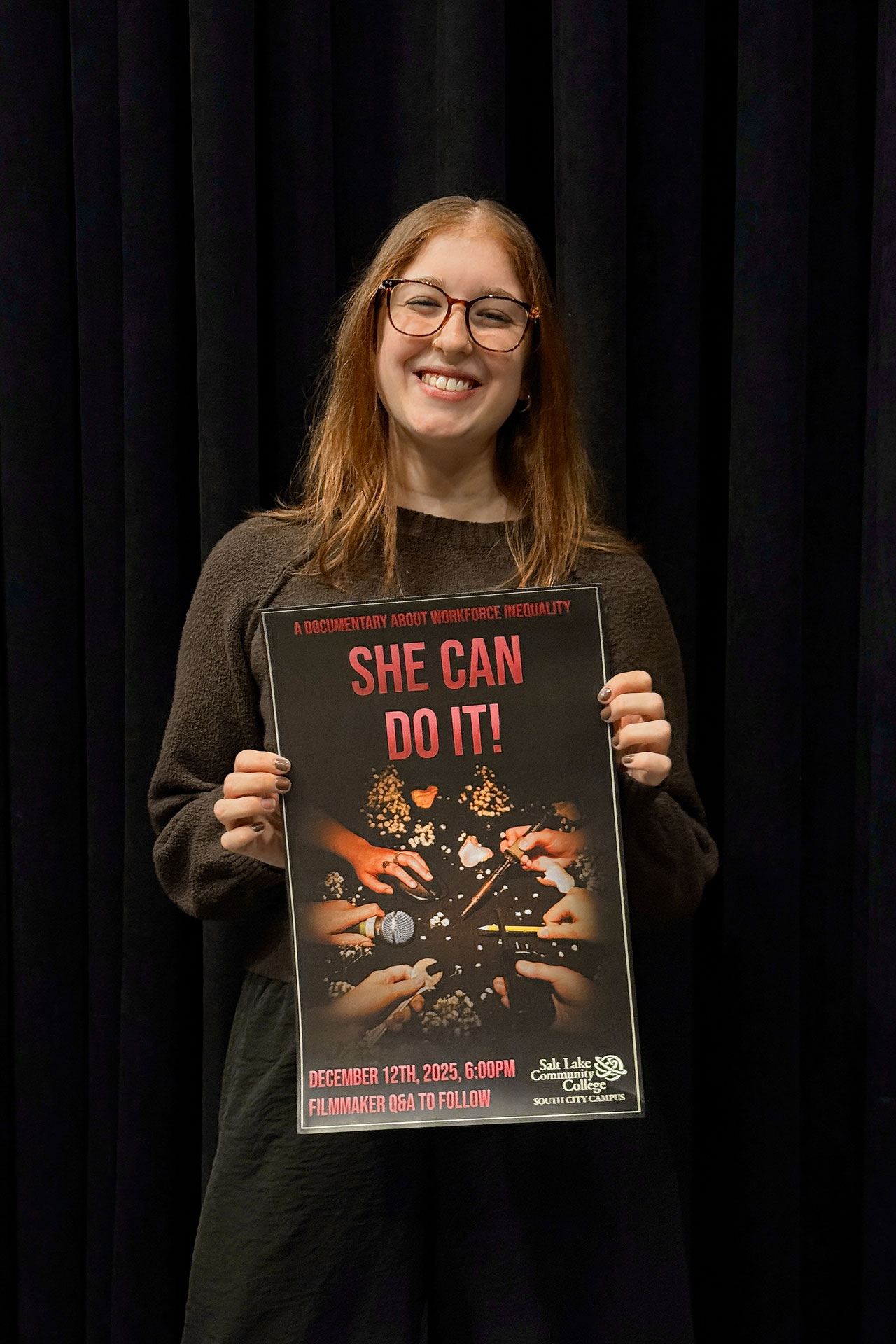 Katie Neal holding a film premiere poster
