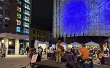 Musical, festival celebrate women’s suffrage and empowerment People walking around on a plaza at night