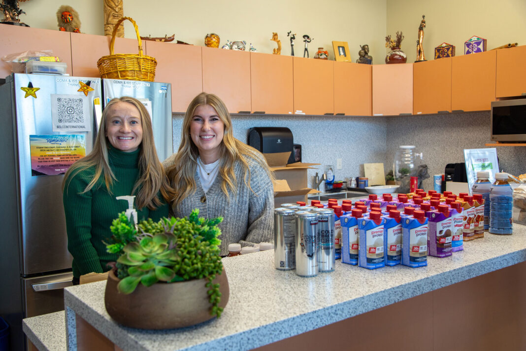 Alison and Madison standing behind a kitchen counter