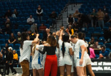SLCC women’s basketball head coach inspires players beyond the court Women's basketball coaches and players huddling in a circle on the court
