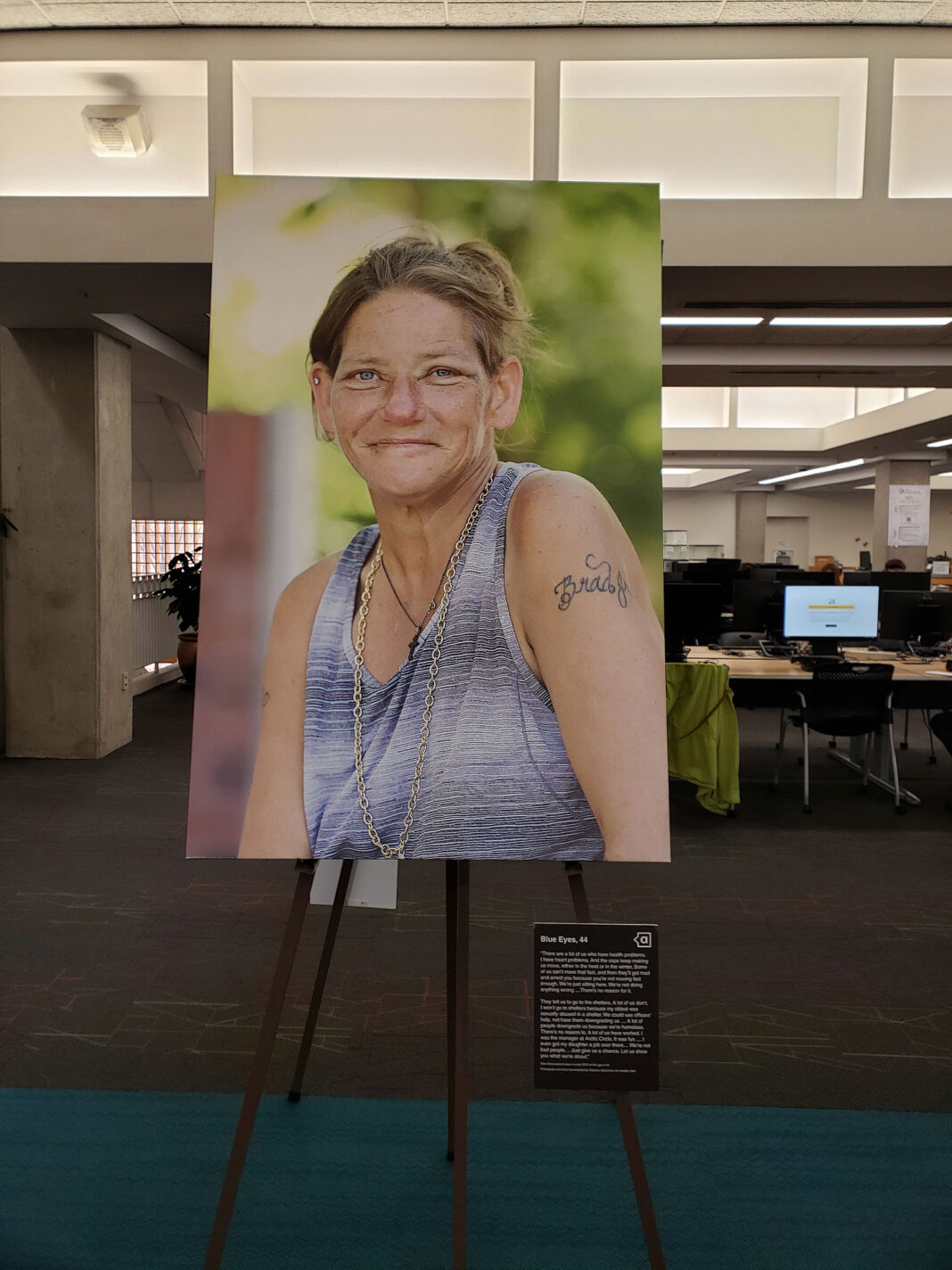 Photograph sitting on easel next to exhibit placards