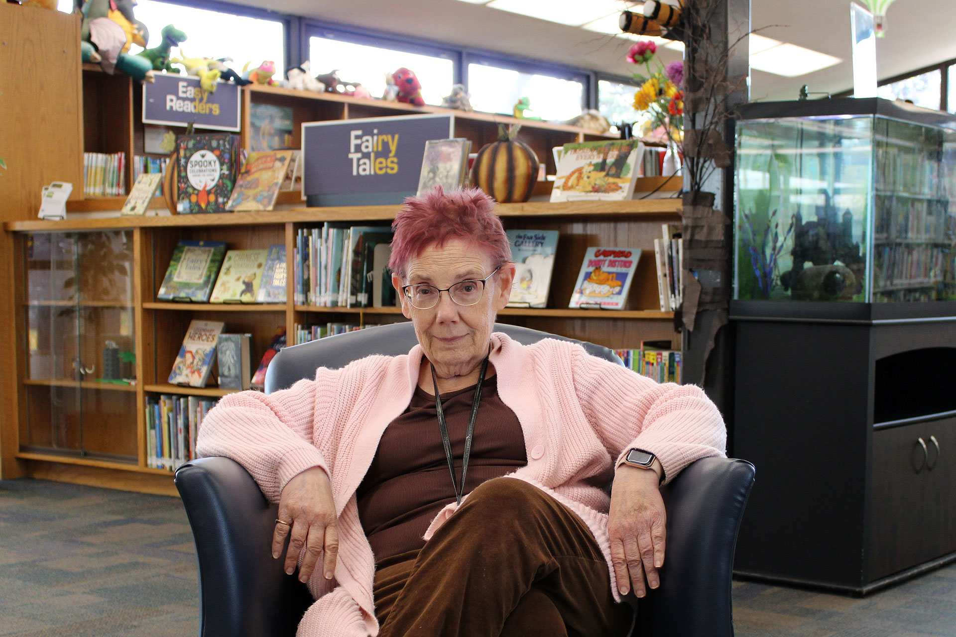 Wanda sitting in a chair in a library