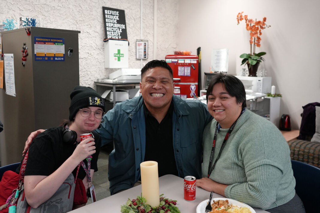 Three people socializing and smiling for a photo