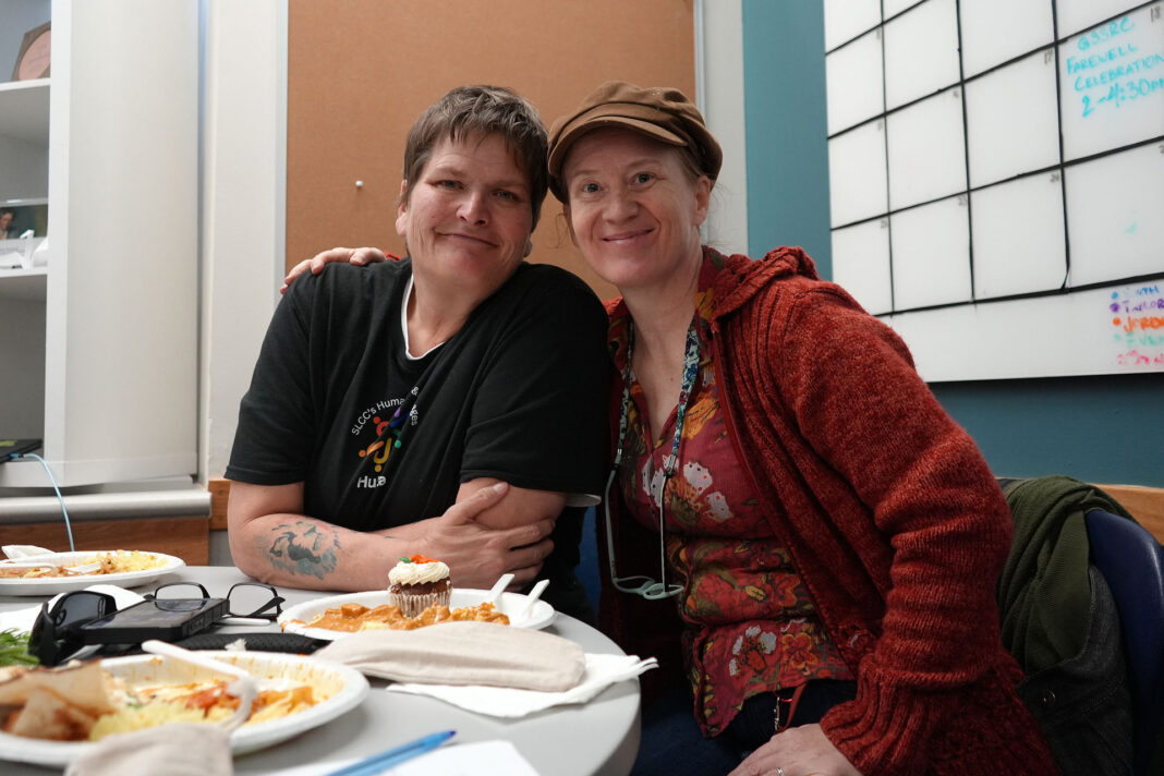 Two people sitting together and smiling for a photo