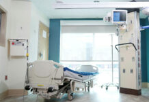 Op-ed: Navigating the world of family caretaking Hospital bed near a glass window