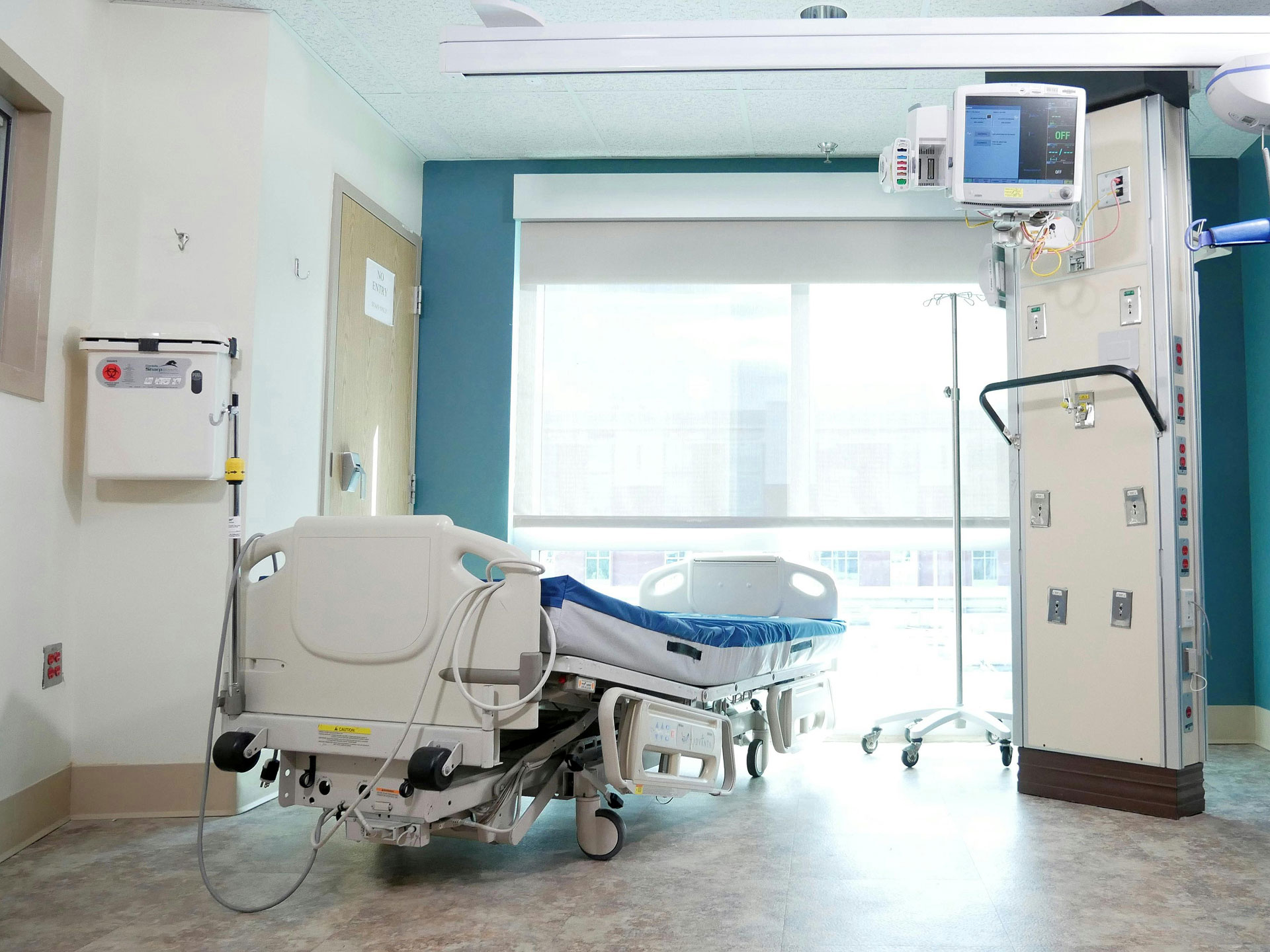 Hospital bed near a glass window