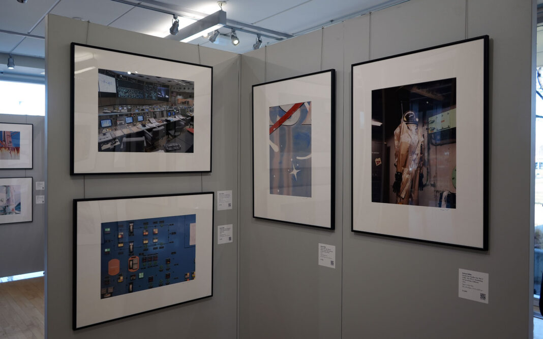 Framed photographs hanging in a gallery