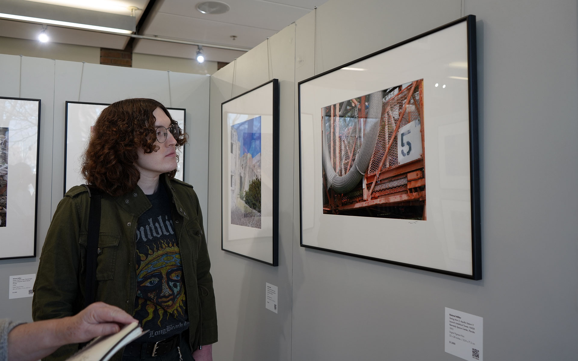 Chris looking at framed photography in a gallery