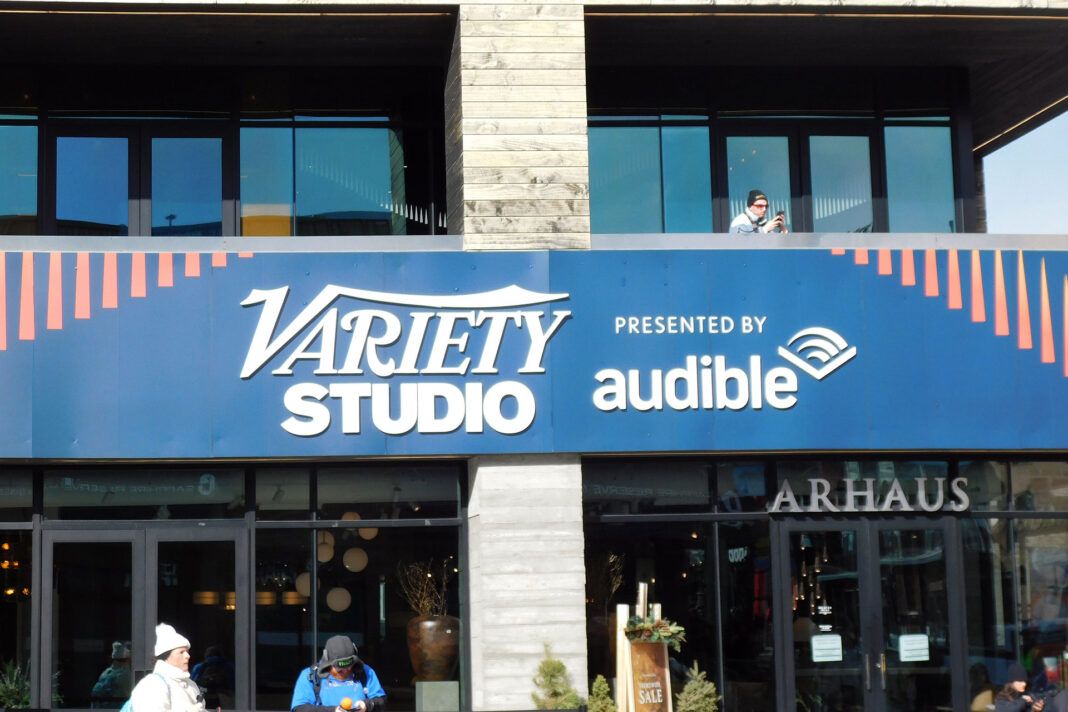Banner on a multilevel building reads "Variety Studio powered by audible"