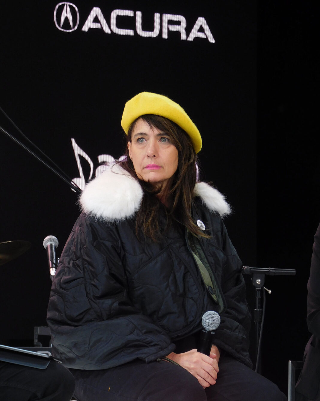 Kathleen Hanna holding a microphone
