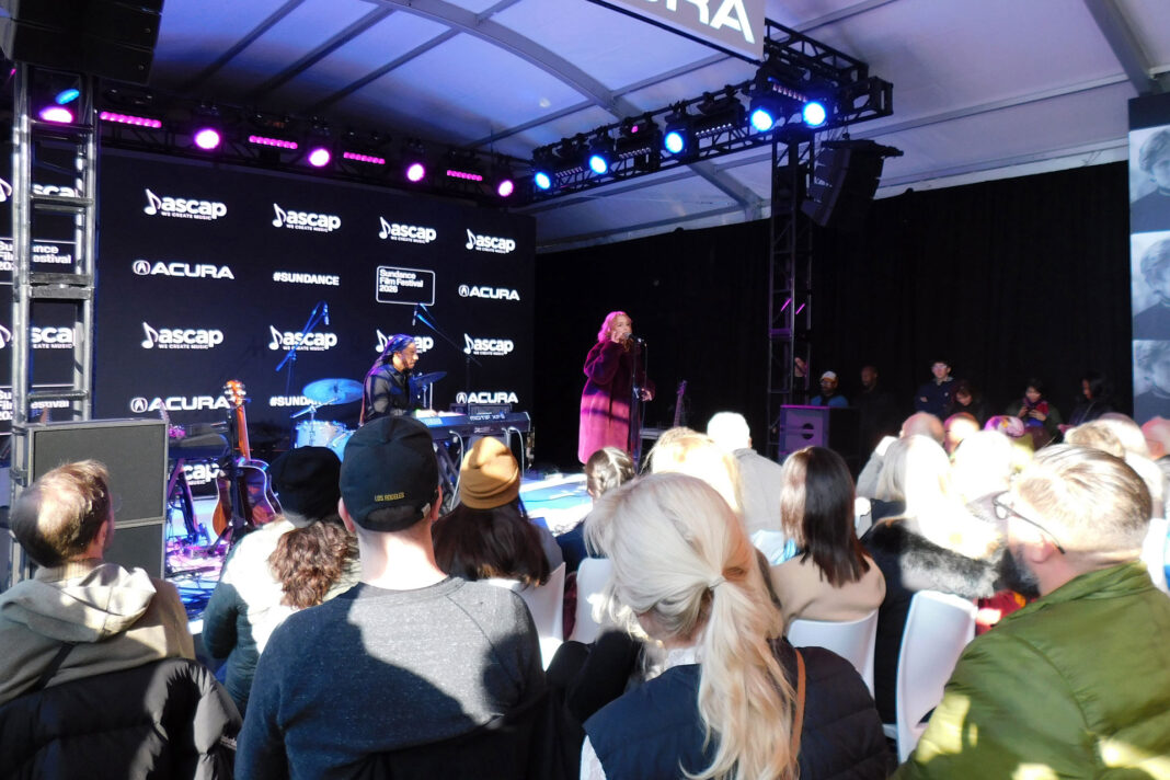 Audience members listening to Nathalia sing