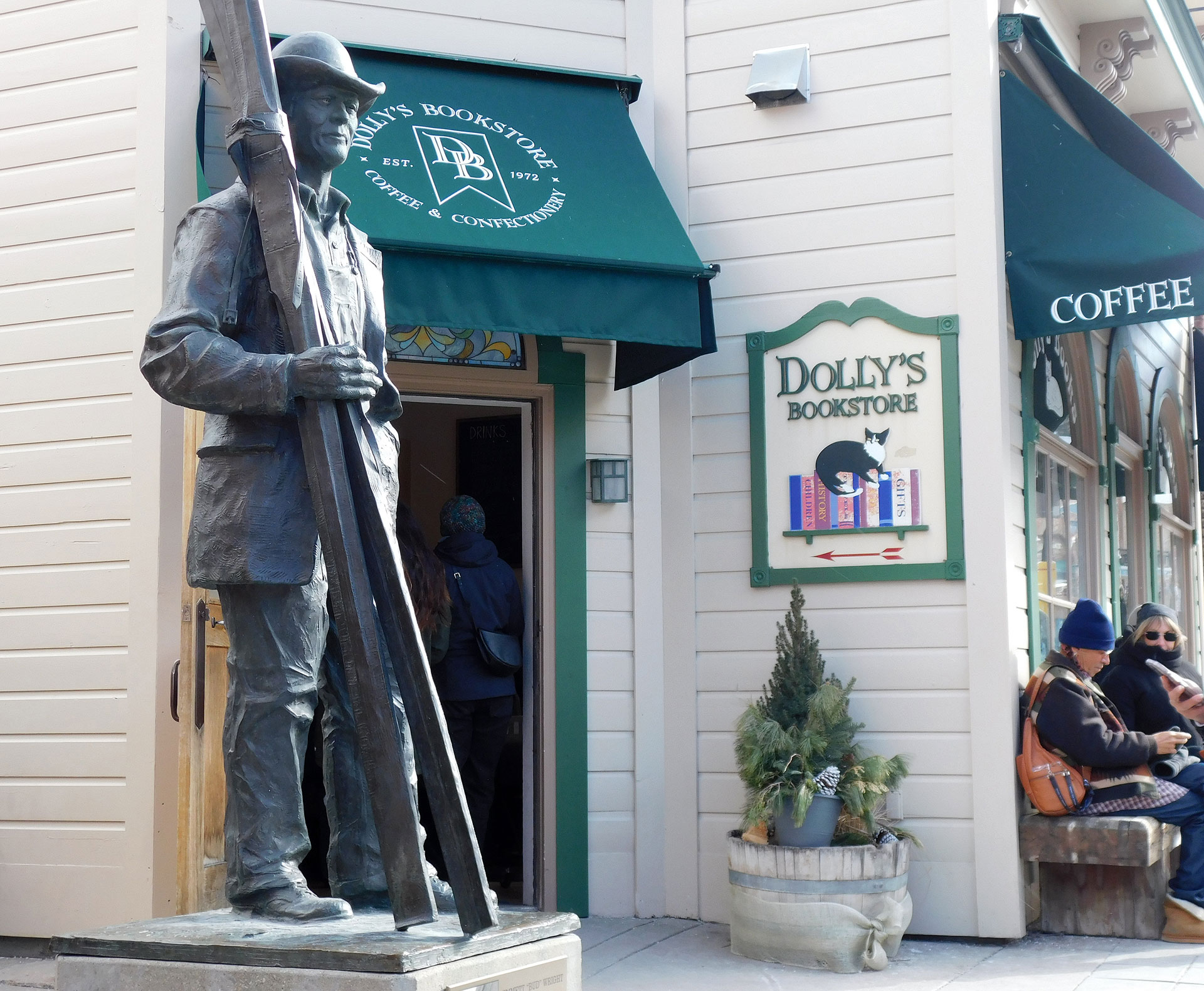 Statue in foreground of entrance to Dolly's Bookstore 