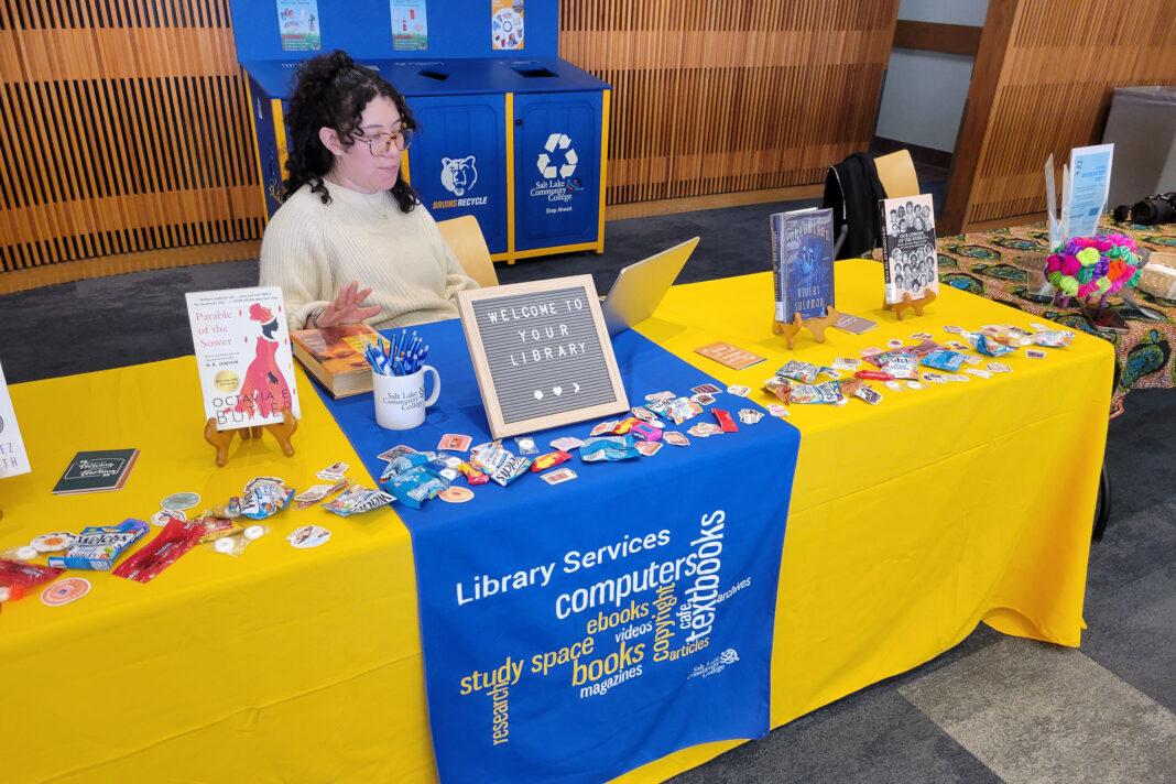 Erica sitting at table with information about campus libraries