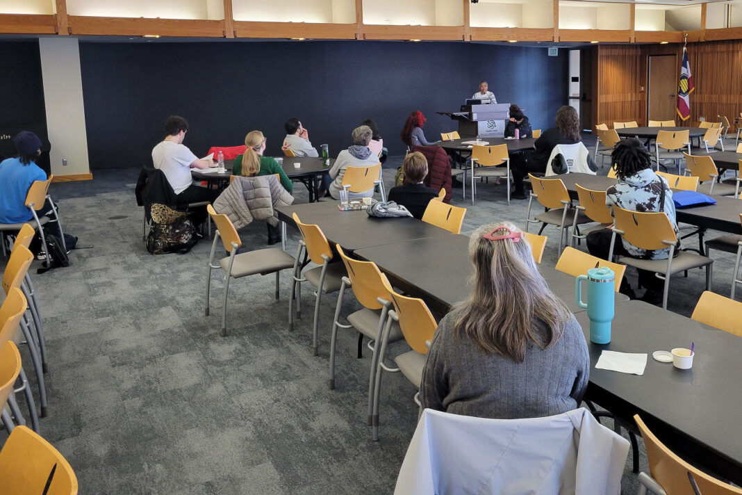 People sitting in the Oak Room listening to a reading