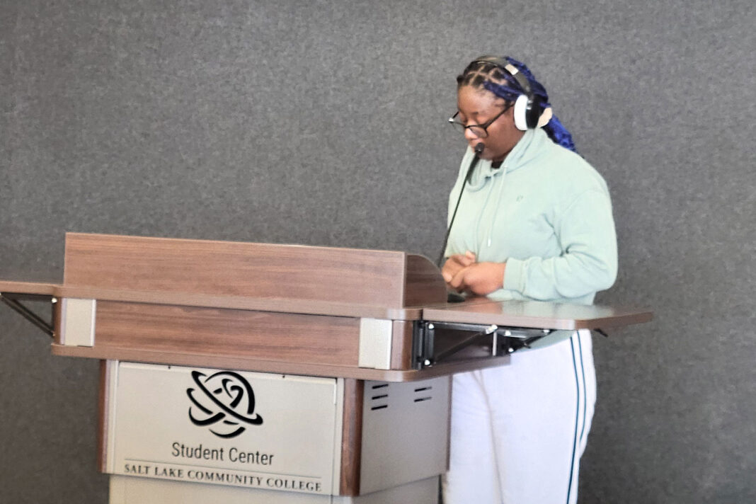 Beck standing at a lectern while reading