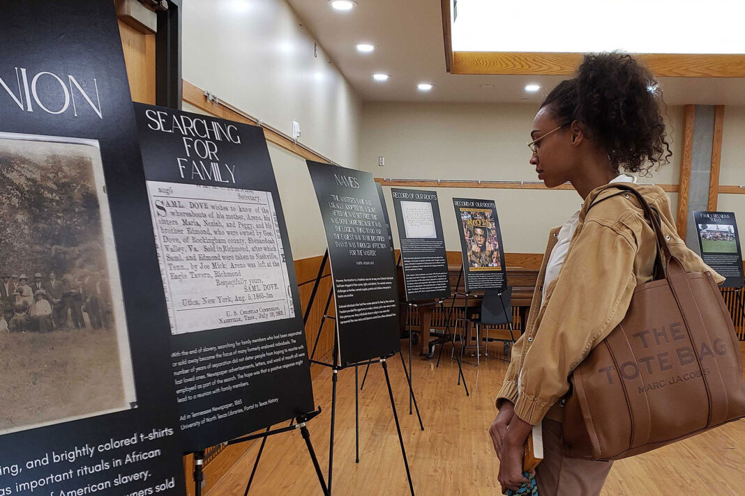 Amanda reading a poster about searching for family