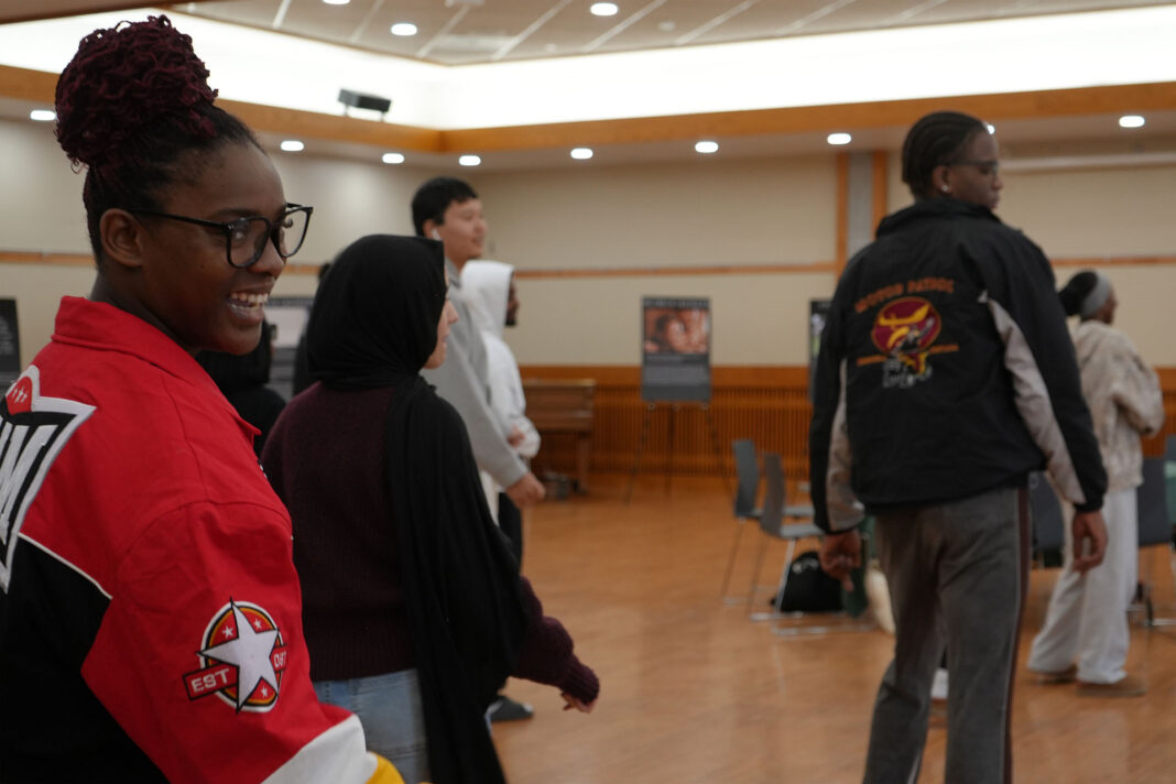 People of various backgrounds dancing in a large room