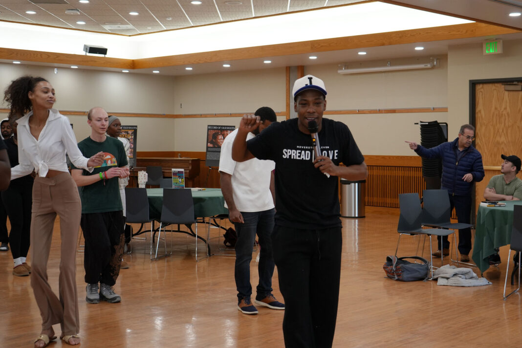 People dancing behind LaDonte in a multipurpose room
