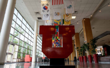 Bill would require coursework accommodations for college students with deeply held beliefs Flags hanging from ceiling above a Block U