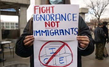 In photos: DHS recruiters on campus sparks SLCC pushback Landscape photo of an SLCC protester with a hand drawn sign